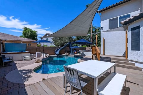 Refreshing pool with slide, Hot tub, seating and more!  Fun all around!
