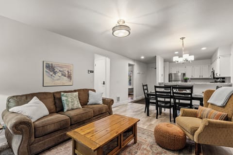 The living room offers a comfortable couch and chair.