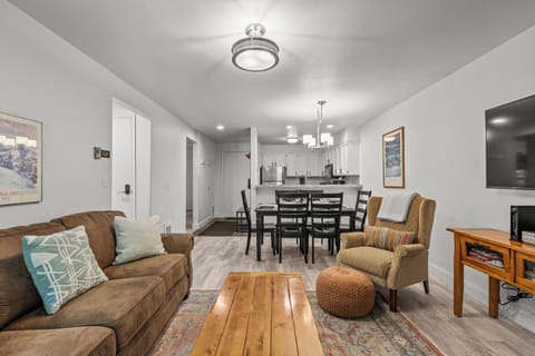 The living room offers a comfortable couch and chair.