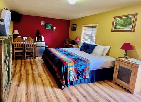 Comfortable King size bed. Dining table, mini-fridge, microwave, and coffee maker.