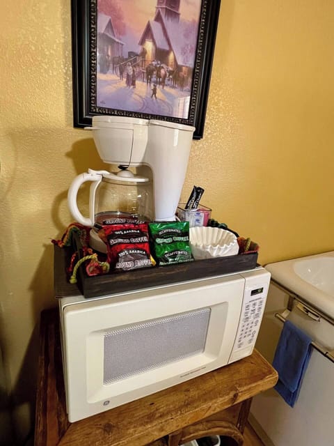 Coffee station with full-sized coffee maker, decaffeinated, and regular coffee.