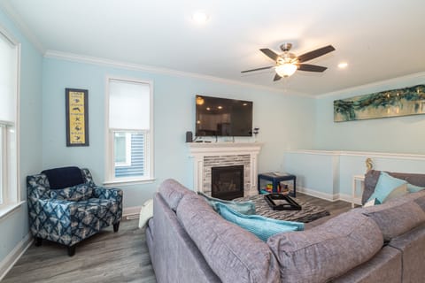 Cozy living room with fireplace, and large smart TV