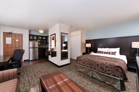 Comfortable suite with a queen bed and kitchenette.
