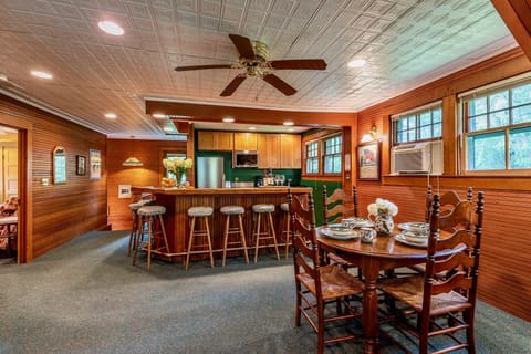 Dining table facing bar and stairs.
