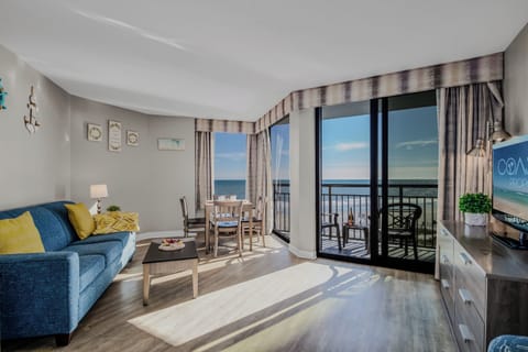 Discover a coastal comfort corner in the oceanfront suite's living area, where the plush couch invites relaxation, offering the perfect spot to enjoy the rhythmic sounds of the waves.
