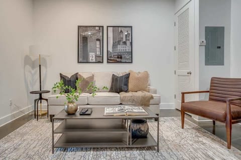 Open concept living area with designer furnishings and smart TV.
