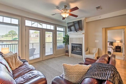 Spacious living room with large windows, cozy seating, and a fireplace – perfect for relaxing with lake views.