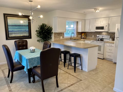 Spacious Dining area with additional bar and stools for seating large groups.