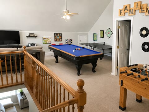Game room with pool table, ping pong, foosball & TV for family fun