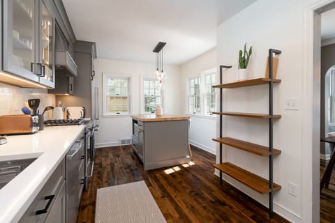 Your gourmet kitchen awaits with sleek gray cabinets, quartz countertops, and gas range for memorable meal prep.