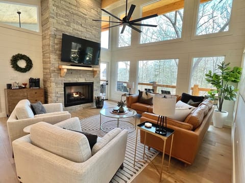 Enjoy all the natural light and the on demand gas fire place in this cozy living room.  All TVs in the home are logged into several streaming services for your complimentary use during your stay!