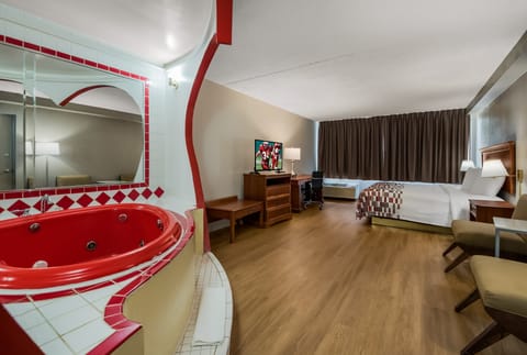 Suite, 1 King Bed, Non Smoking, Jetted Tub | Premium bedding, blackout drapes, iron/ironing board