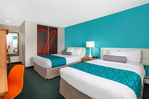 Premium bedding, desk, laptop workspace, blackout drapes