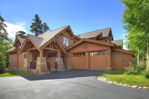 The rustic façade of Mountain Thunder Lodge blends natural timber and stone, offering a welcoming gateway to your Breckenridge retreat.