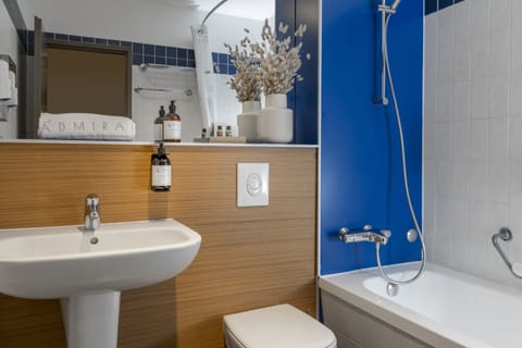 Eco-friendly toiletries, hair dryer, slippers, towels