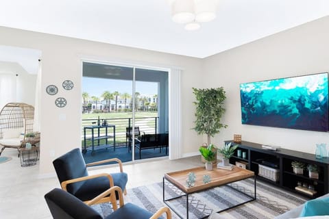 Living Room with 70` Smart TV and Pool View!#Disney #Parks #kingdom #springs #StoreyLake #Apartment #Vacation #Rental #waterpark #Kissimmee #Orlando #universal #citywalk