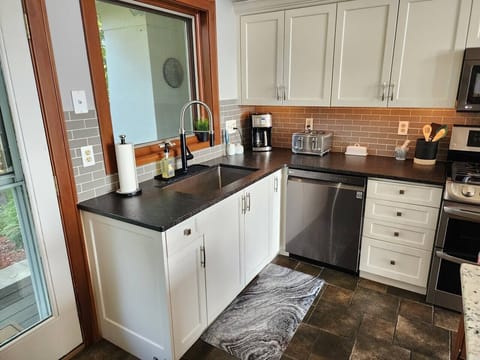 Kitchen is well stocked with a cofee maker, toaster, spices, plates, cups, silverware, etc!
