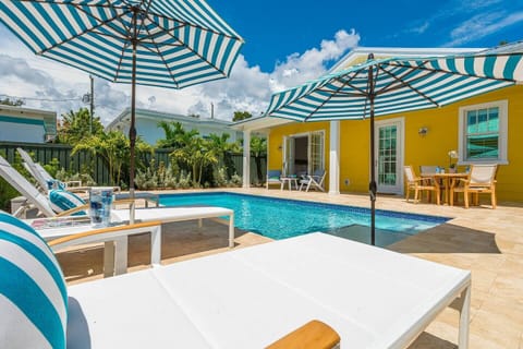 Truly an oasis! The pool is breathtaking, especially at night with the color-changing pool lights. There are loungers, an umbrella along the pool, and a built-in umbrella on the first step of the pool for extra shade. BBQ & sit at the 4 seater dining table