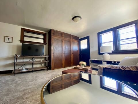 Spacious living room with built in closet for storage and private access to a small second floor patio.