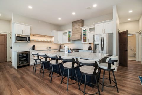 2nd floor the main kitchen island with 6 bar stools. 