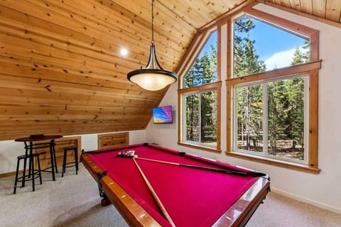Tahoe Donner game room with pool table, foosball, TV, toys and sleeper sofa—an inviting space for family-friendly entertainment after a day of Truckee adventures.