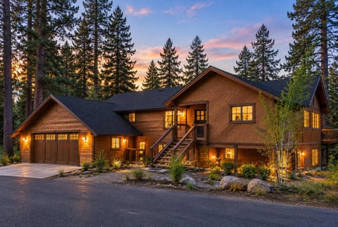 The Tahoe Treehouse — a recently remodeled 4-bedroom retreat surrounded by towering pines, with filtered Lake Tahoe views, a private hot tub, central A/C, high-end finishes, and professional hospitality.
