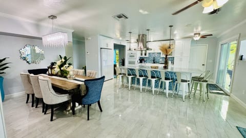 Dining table holds 8 people and kitchen island holds 10 people for a total of 18