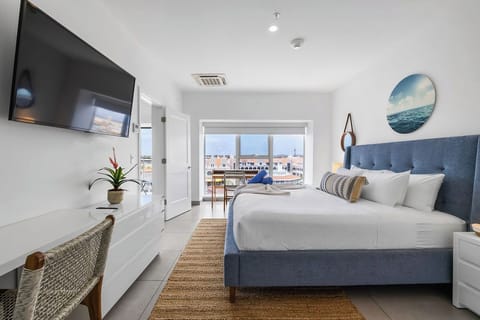 Welcome to your bright inviting bedroom, with soft white linens creating a relaxing retreat. Floor-to-ceiling glass windows let you wake up to beautiful surroundings and enjoy the view from the comfort of your bed.