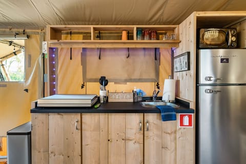 An apartment sized fridge with a microwave.