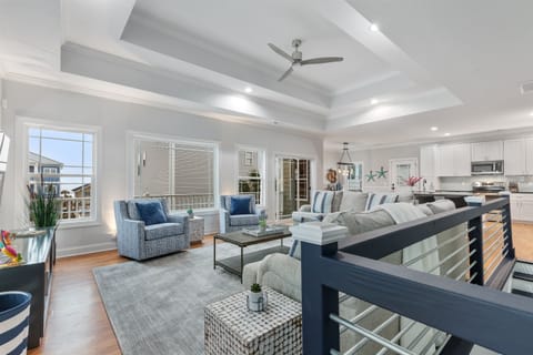 WOW What a View! The open floor plan living room, kitchen and dinign room ensures no one is left out.  Plenty of seating for the family to chat, play board games or even take in the big game!