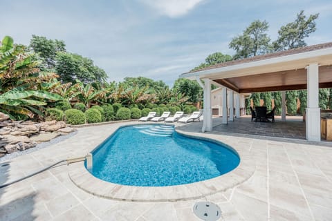 Gorgeous outdoor pool with pool chairs and relaxing patio space
