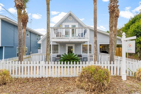 Covered and fenced front patio offers a private outdoor space to relax, enjoy the coastal breeze, or unwind after beach days.