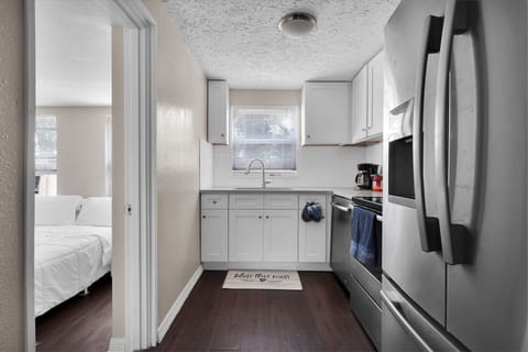 Kitchen w/ plates, bowls, cups, coffee, dishwasher, microwave, pots & pans