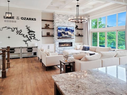 Spacious living room with sweeping lake views from every angle.