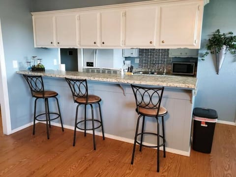 Enjoy a cozy meal or chat over drinks at the inviting countertop with comfortable chairs.