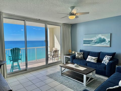 Gulf-front living space with Smart TV and sleeper sofa — relax after beach days with ocean views.