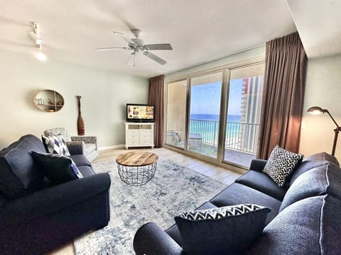 Beachfront living room with floor-to-ceiling Gulf views, Smart TV, and new sleeper sofa for relaxing after beach days.