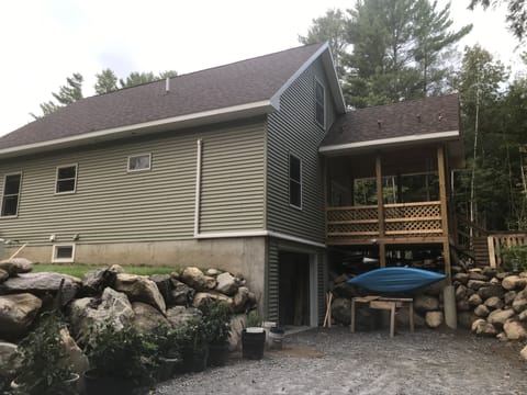 Rear porch/ stone walls. Garage.