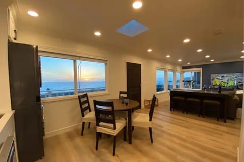 The kitchen and living room with many windows facing the Pacific Ocean