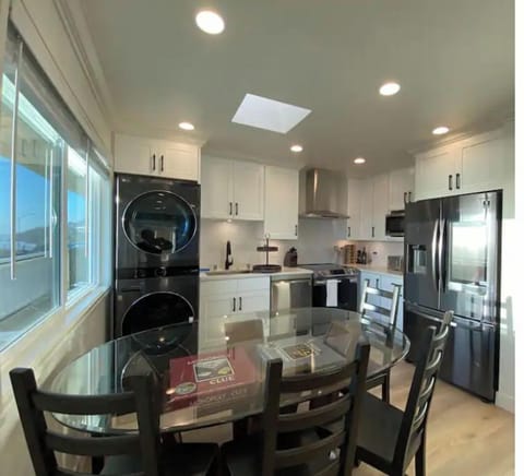 Kitchen with a smart refrigerator, W/D, dishwasher, microwave, range and table