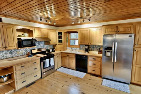 Our open-concept kitchen is fully stocked for making yummy meals for your group.