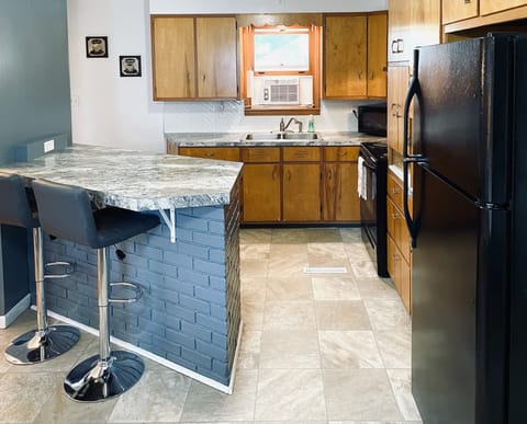 Kitchen island has 2 bar stools on either side