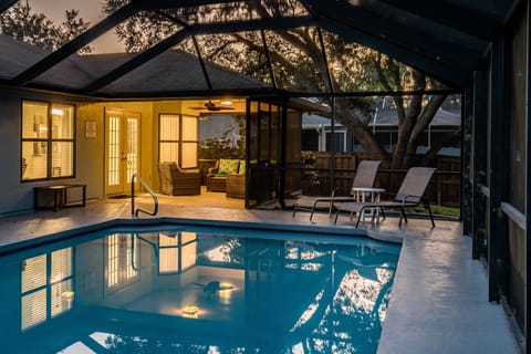Beautifully lit lanai with oversized heated pool for lounging and grilling.