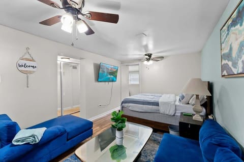 Main Living Area
- Queen bed 
- Loveseat & chair
- 50" Smart HDTV mounted to wall
- 2x ceiling fans
- Beautiful ocean-mosaic paintings