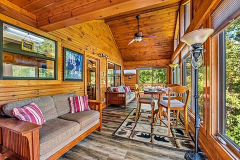 Large sunroom with big windows, comfortable seating, lots of natural light and mountain views.