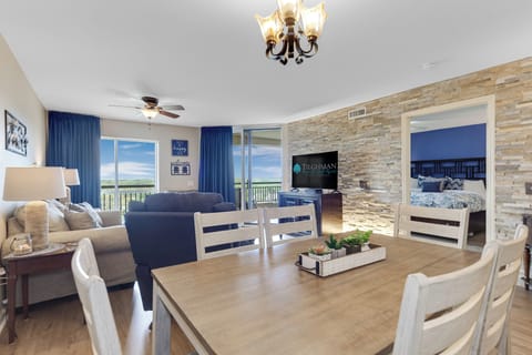 Your spacious retreat features an open floor plan where you can gather around the dining table while enjoying stunning views through floor-to-ceiling windows.