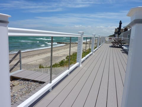 Relax on a wrap-around deck or walk onto the beach.