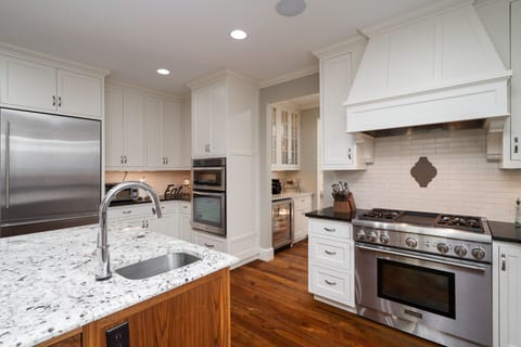 Your gourmet kitchen awaits with granite countertops, stainless steel appliances, and warm wood floors perfect for creating memorable meals.