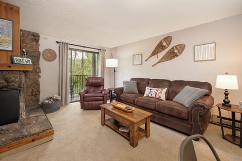 Sink into plush leather furniture by your stone fireplace, where rustic charm meets modern comfort in this inviting mountain retreat.