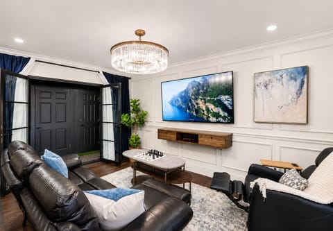 Relax and unwind in the spacious open-concept living area, featuring a 65" Smart TV—perfect for enjoying your favorite shows.
